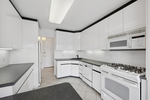 166-25 Powells Cove Blvd Unit 7E, Beechhurst, NY 11357 - kitchen featuring white cabinets, dark countertops, white appliances, and a sink