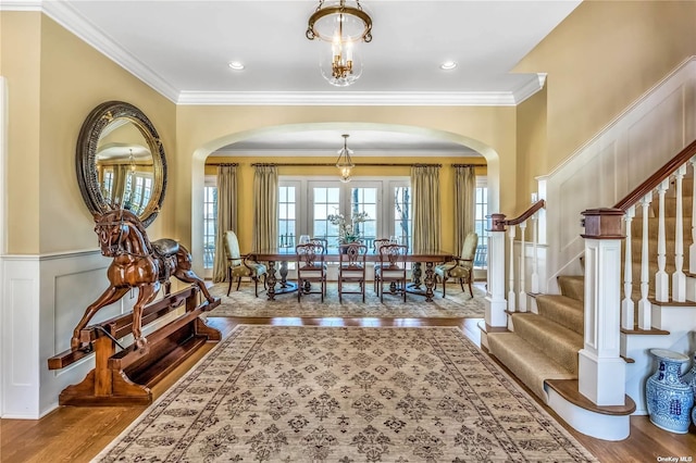 279 Little Neck Rd, Centerport, NY 11721 - interior space with wainscoting, wood finished floors, and arched walkways