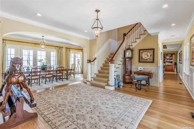 279 Little Neck Rd, Centerport, NY 11721 - foyer featuring arched walkways, recessed lighting, stairway, and light wood finished floors