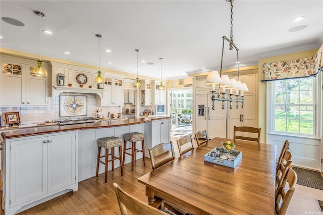 279 Little Neck Rd, Centerport, NY 11721 - dining room featuring crown molding, light wood-style flooring, and recessed lighting