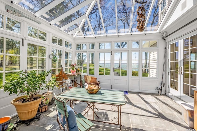 279 Little Neck Rd, Centerport, NY 11721 - sunroom / solarium with a skylight, high vaulted ceiling, french doors, and stone tile flooring