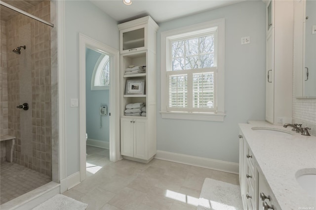279 Little Neck Rd, Centerport, NY 11721 - bathroom featuring double vanity, tiled shower, and a sink