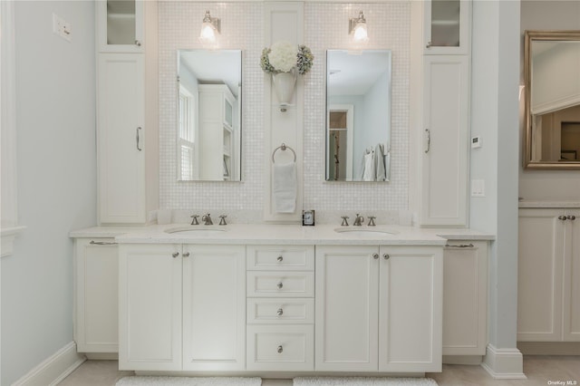 279 Little Neck Rd, Centerport, NY 11721 - bathroom featuring a sink, decorative backsplash, and double vanity