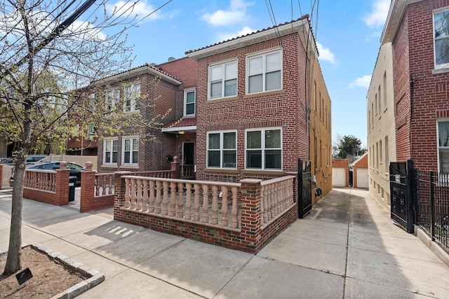 townhome / multi-family property featuring brick siding, a garage, and fence
