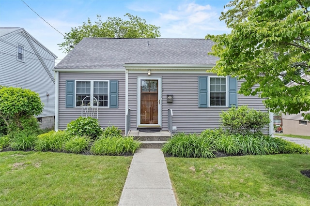 7 Wilson Blvd, Poughkeepsie, NY 12603 - view of front of house with a front yard and a shingled roof