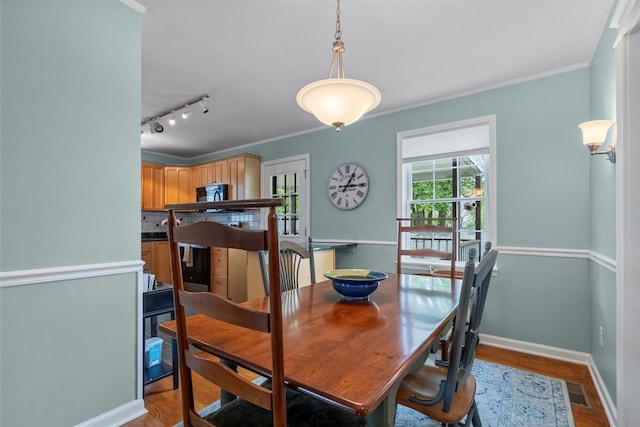 7 Wilson Blvd, Poughkeepsie, NY 12603 - dining room with wood finished floors, baseboards, rail lighting, and ornamental molding