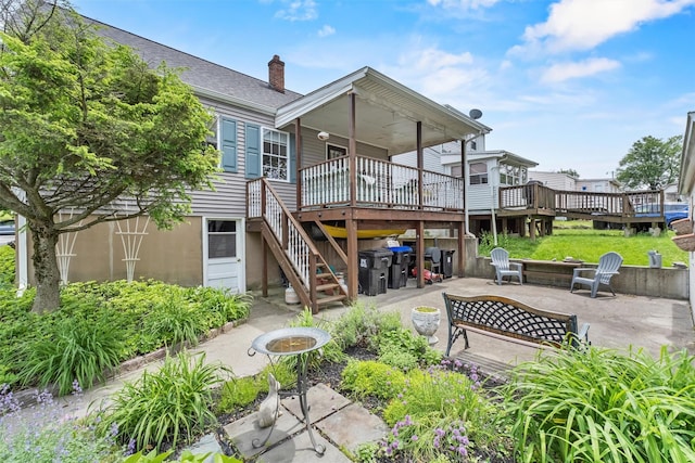 7 Wilson Blvd, Poughkeepsie, NY 12603 - back of property featuring a chimney, stairway, a patio, and a wooden deck
