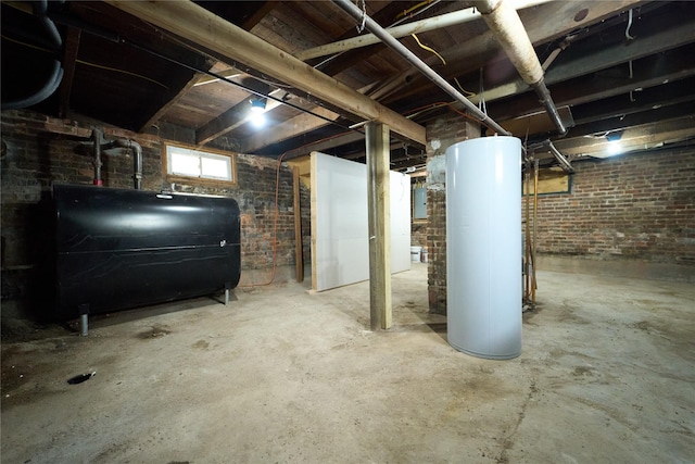 below grade area featuring brick wall, heating fuel, and gas water heater