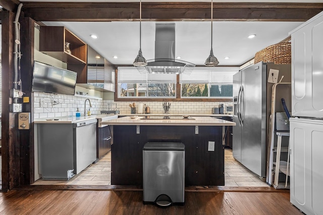 108 Wayne Ave, White Plains, NY 10606 - kitchen with stainless steel appliances, light countertops, a center island, extractor fan, and backsplash