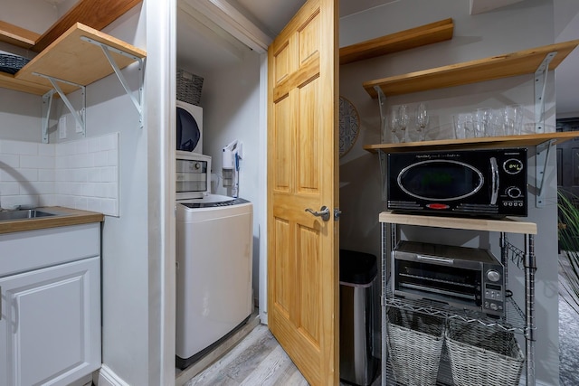 108 Wayne Ave, White Plains, NY 10606 - laundry room featuring washer / clothes dryer, laundry area, and light wood-type flooring