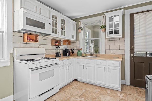 108 Wayne Ave, White Plains, NY 10606 - kitchen with white appliances, decorative backsplash, light countertops, a sink, and crown molding