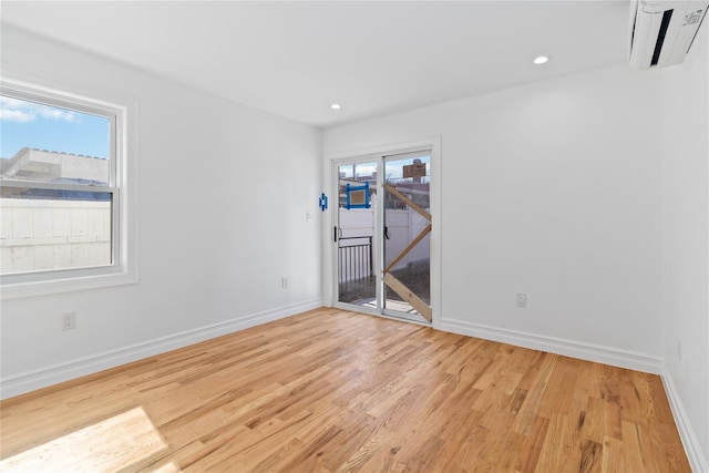 unfurnished room with baseboards, a healthy amount of sunlight, recessed lighting, and light wood-type flooring