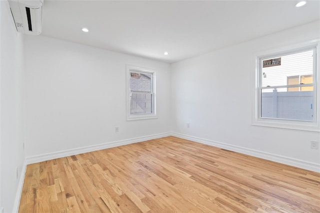 spare room with light wood-style flooring, baseboards, and recessed lighting