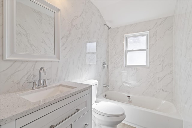 bathroom featuring vanity, tile walls, toilet, backsplash, and washtub / shower combination