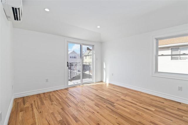 spare room with baseboards, light wood-type flooring, visible vents, and recessed lighting