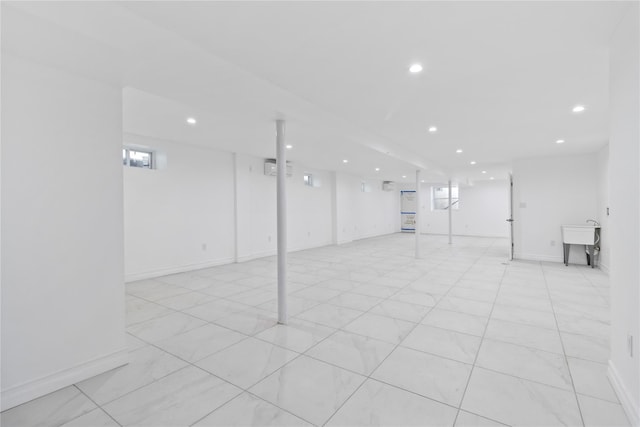 basement with baseboards and recessed lighting