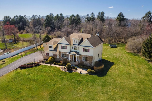 3 Madonna Dr, Lagrangeville, NY 12540 - traditional-style house with a front yard, driveway, stone siding, and fence