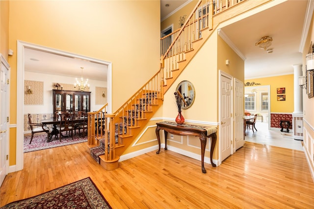 3 Madonna Dr, Lagrangeville, NY 12540 - staircase featuring crown molding, an inviting chandelier, hardwood / wood-style floors, and wainscoting