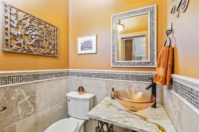 19 Stillwood Rd, Brookhaven, NY 11719 - bathroom with a sink, a wainscoted wall, toilet, and tile walls