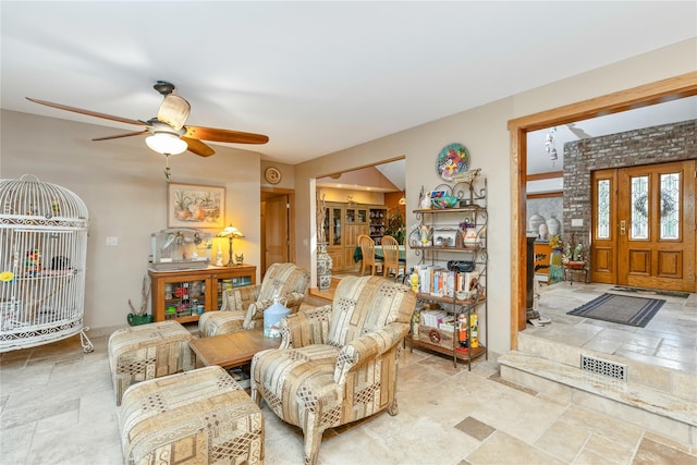 19 Stillwood Rd, Brookhaven, NY 11719 - living room featuring visible vents, a ceiling fan, and stone tile floors