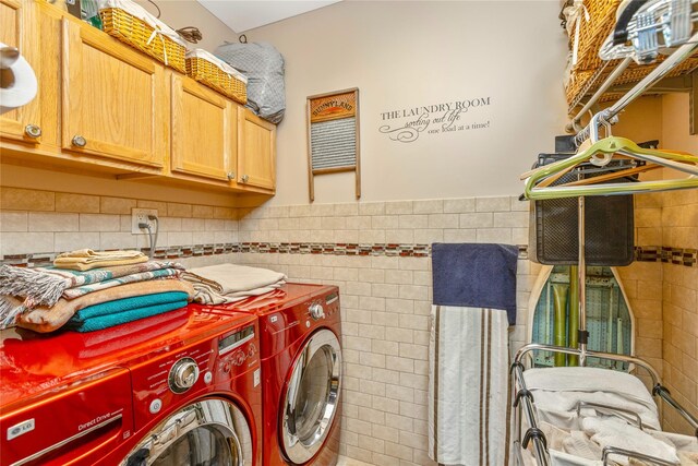 19 Stillwood Rd, Brookhaven, NY 11719 - clothes washing area with cabinet space, tile walls, a wainscoted wall, and washing machine and clothes dryer