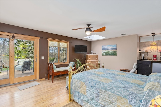 19 Stillwood Rd, Brookhaven, NY 11719 - bedroom featuring a ceiling fan, visible vents, a skylight, wood finished floors, and access to outside