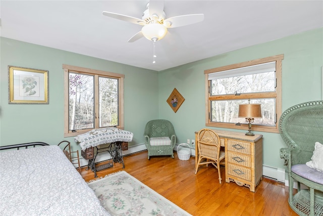 19 Stillwood Rd, Brookhaven, NY 11719 - bedroom with baseboards, a baseboard radiator, and wood finished floors