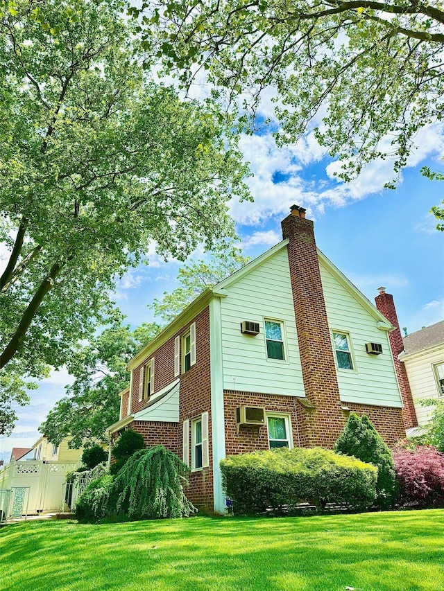 212-04 50th Ave, Bayside, NY 11364 - view of property exterior with brick siding, a chimney, and a wall unit AC