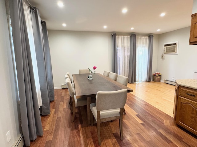 212-04 50th Ave, Bayside, NY 11364 - dining area featuring an AC wall unit, a baseboard radiator, wood finished floors, and recessed lighting