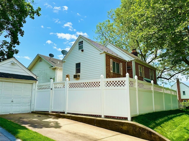 212-04 50th Ave, Bayside, NY 11364 - view of property exterior with a garage, a chimney, driveway, brick siding, and cooling unit