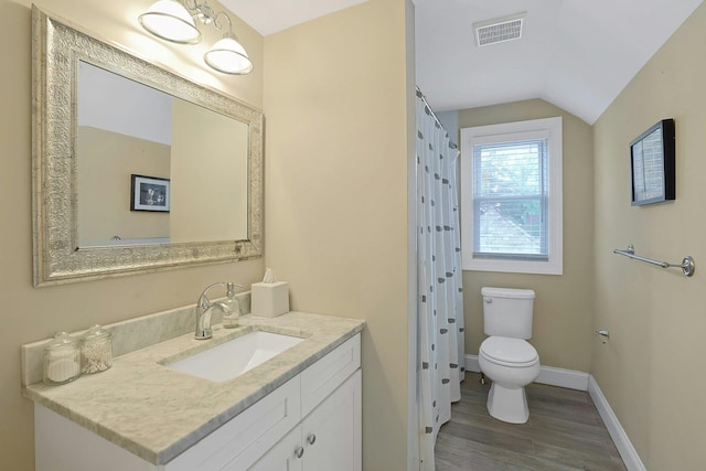 bathroom with toilet, wood finished floors, vanity, baseboards, and vaulted ceiling