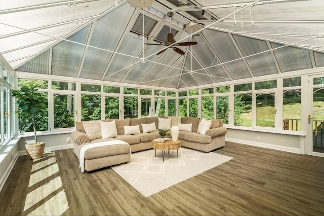 sunroom / solarium featuring baseboards, wood finished floors, ceiling fan, and lofted ceiling