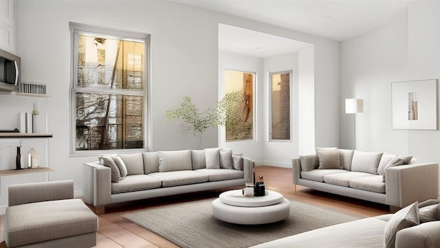 living area with light wood-style floors and plenty of natural light