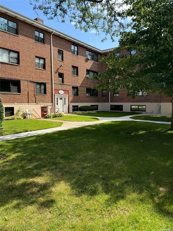 91 Tulip Ave Unit B-2, Floral Park, NY 11001 - view of property's community featuring a lawn