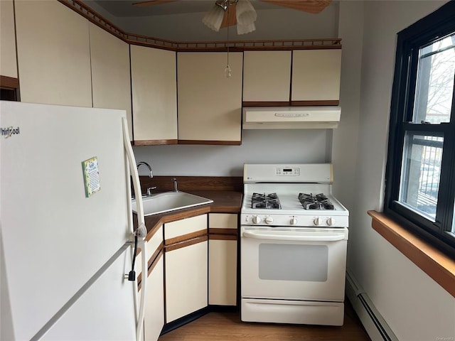 91 Tulip Ave Unit B-2, Floral Park, NY 11001 - kitchen featuring white appliances, dark countertops, under cabinet range hood, a sink, and a baseboard heating unit