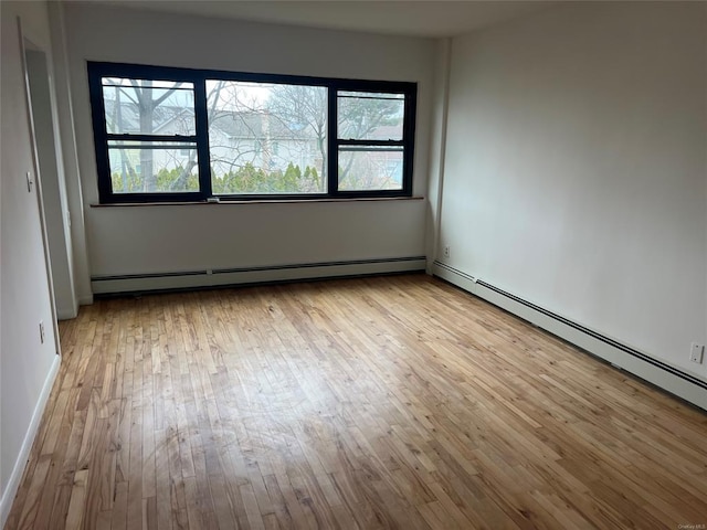 91 Tulip Ave Unit B-2, Floral Park, NY 11001 - unfurnished room with hardwood / wood-style floors, a wealth of natural light, and a baseboard radiator