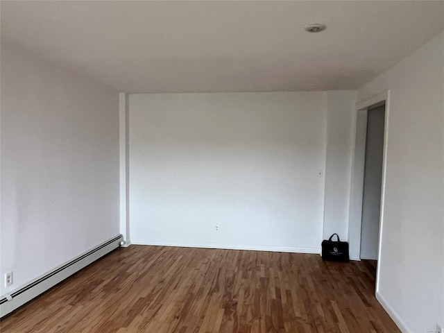 91 Tulip Ave Unit B-2, Floral Park, NY 11001 - spare room with baseboards, baseboard heating, and wood finished floors
