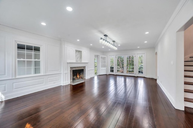 85 Station Rd, Great Neck, NY 11023 - unfurnished living room featuring stairs, recessed lighting, ornamental molding, and dark wood-style floors