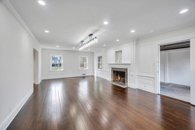 85 Station Rd, Great Neck, NY 11023 - unfurnished living room featuring a premium fireplace, dark wood finished floors, baseboards, ornamental molding, and recessed lighting