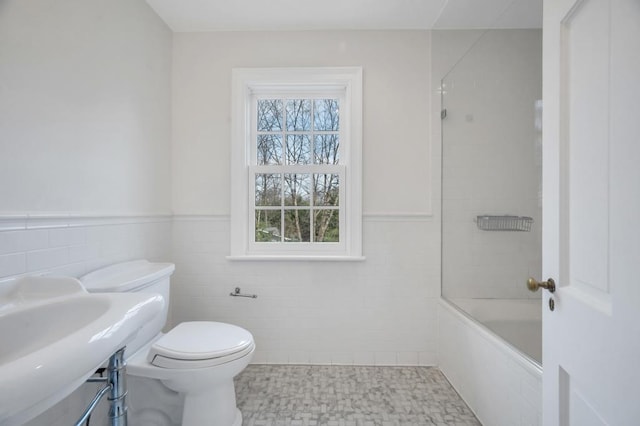 85 Station Rd, Great Neck, NY 11023 - full bath with toilet, a wainscoted wall, shower / bathing tub combination, and tile walls