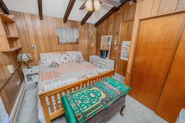 carpeted bedroom with baseboard heating, wood walls, and beam ceiling