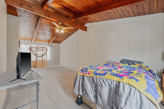 carpeted bedroom with vaulted ceiling with beams, a ceiling fan, wood ceiling, and wooden walls