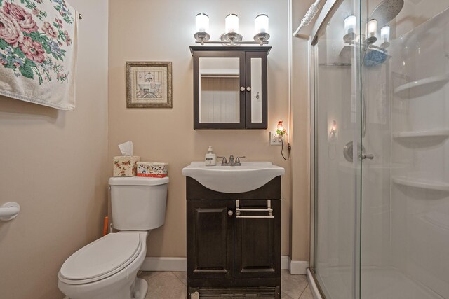 full bathroom with vanity, toilet, tile patterned flooring, and a stall shower