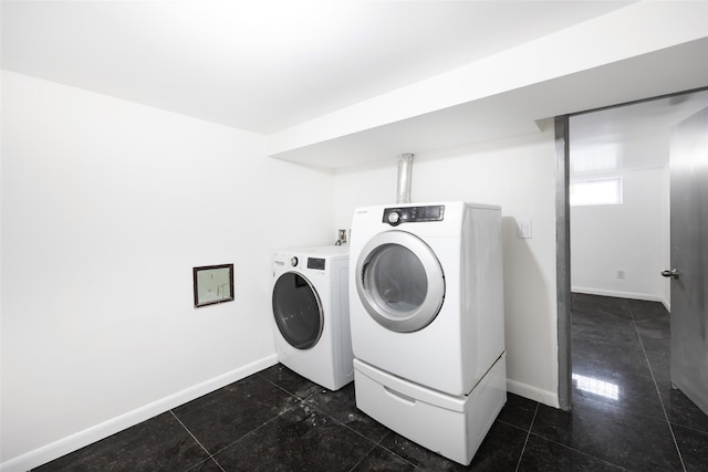 laundry area featuring baseboards and independent washer and dryer