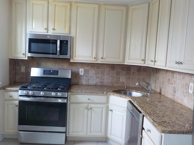 260-37 Union Tpke Fl 2Nd, Glen Oaks, NY 11004 - kitchen with light stone countertops, appliances with stainless steel finishes, a sink, and tasteful backsplash