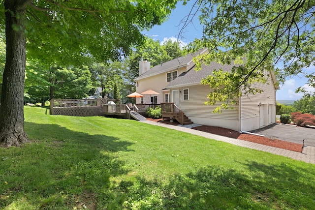 34 Melissa Ln, Washingtonville, NY 10992 - view of grassy yard featuring a wooden deck and asphalt driveway