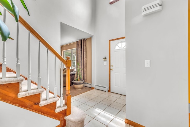 34 Melissa Ln, Washingtonville, NY 10992 - entrance foyer featuring stairway, a towering ceiling, light tile patterned flooring, and baseboard heating