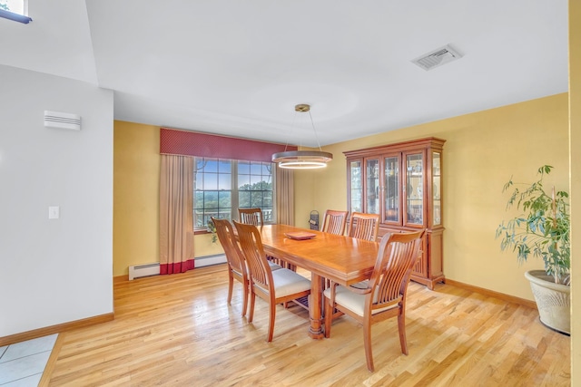 34 Melissa Ln, Washingtonville, NY 10992 - dining area with light wood finished floors and a baseboard heating unit