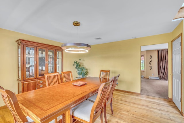 34 Melissa Ln, Washingtonville, NY 10992 - dining room with light wood-style floors and a baseboard radiator