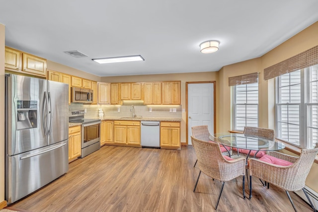 34 Melissa Ln, Washingtonville, NY 10992 - kitchen featuring stainless steel appliances, light brown cabinets, light wood-style floors, light countertops, and backsplash